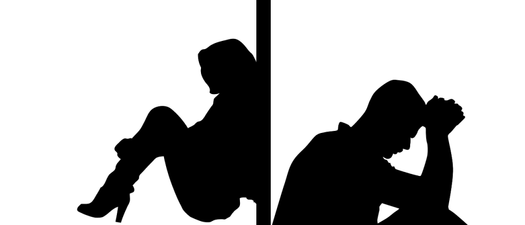 silhouette image of man and women separated by wall